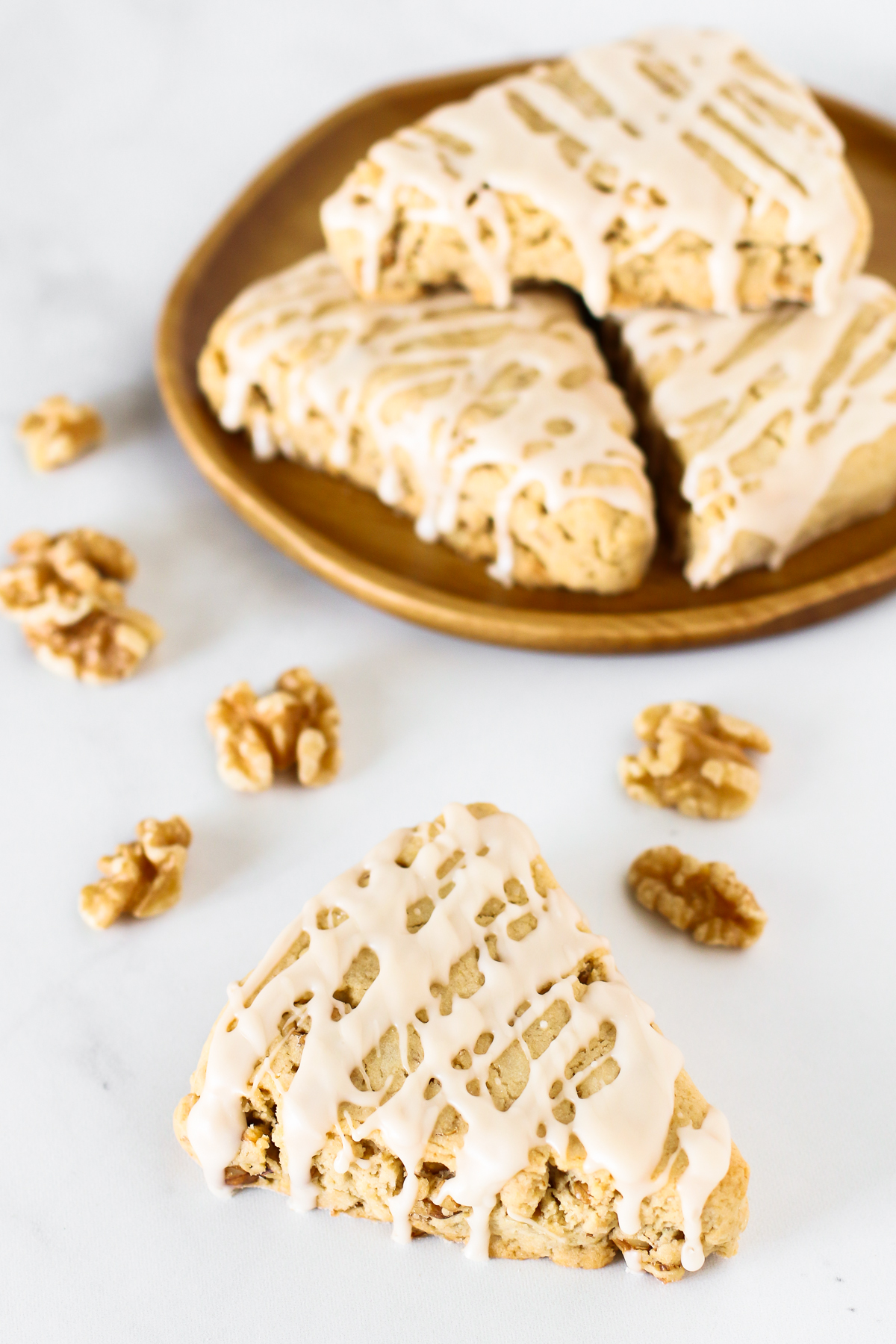 Gluten Free Vegan Maple Walnut Scones. Tender scones with toasted walnuts, covered in a delicious maple glaze.