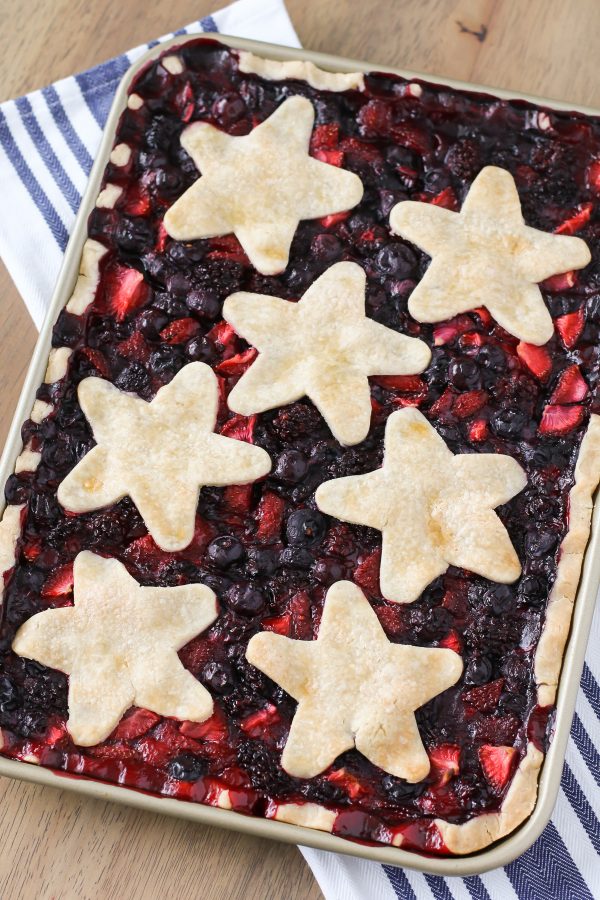 Gluten Free Vegan Triple Berry Slab Pie. Flaky pie crust, filled with fresh strawberries, blueberries and blackberries. Baked in a sheet pan until bubbly and golden brown!