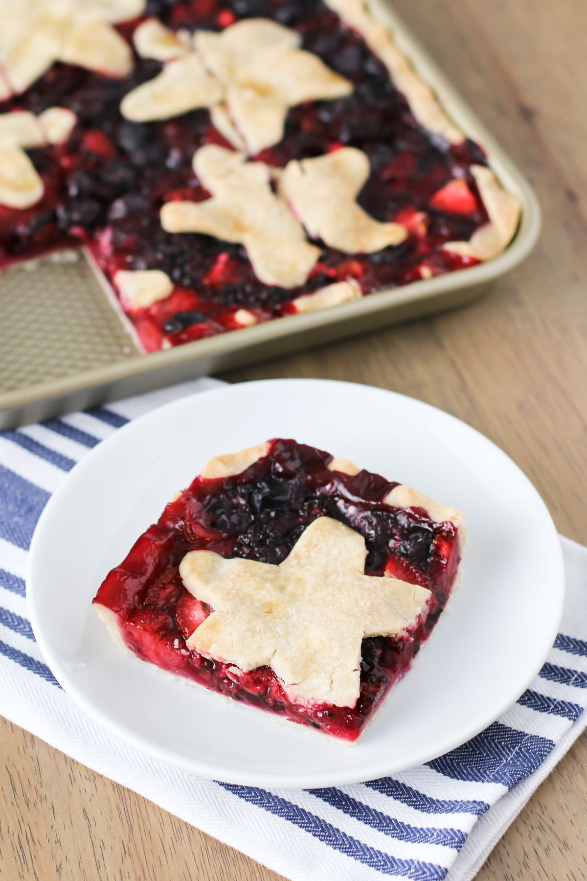 Gluten Free Vegan Triple Berry Slab Pie. Flaky pie crust, filled with fresh strawberries, blueberries and blackberries. 