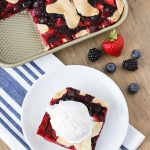 Gluten Free Vegan Triple Berry Slab Pie. Flaky pie crust, filled with fresh strawberries, blueberries and blackberries. Baked in a sheet pan until bubbly and golden brown!