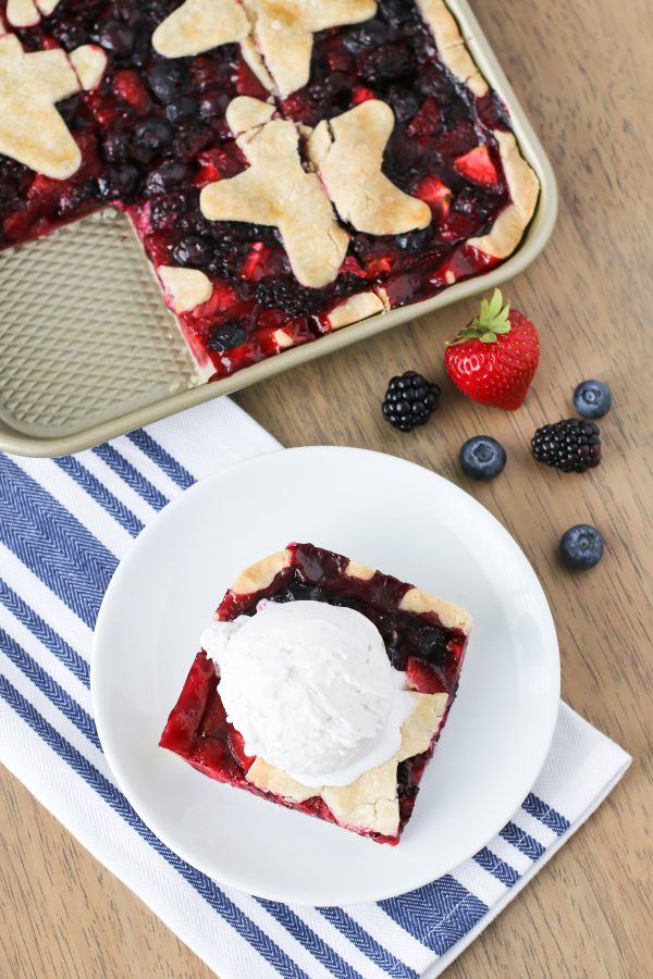 Gluten Free Vegan Triple Berry Slab Pie. Flaky pie crust, filled with fresh strawberries, blueberries and blackberries. Baked in a sheet pan until bubbly and golden brown!