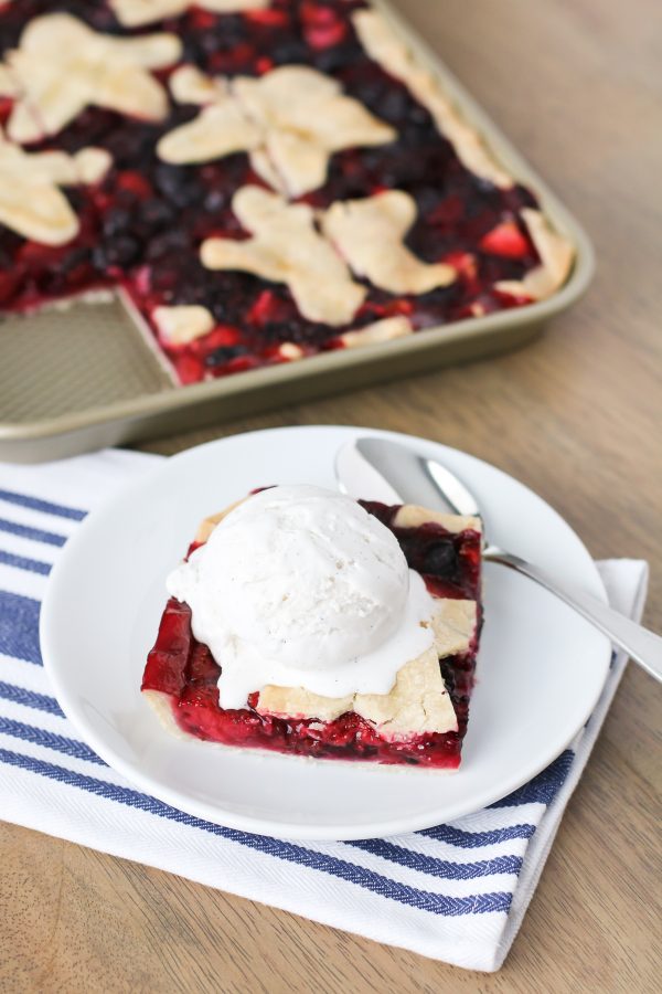 Gluten Free Vegan Triple Berry Slab Pie. Flaky pie crust, filled with fresh strawberries, blueberries and blackberries. Baked in a sheet pan until bubbly and golden brown!