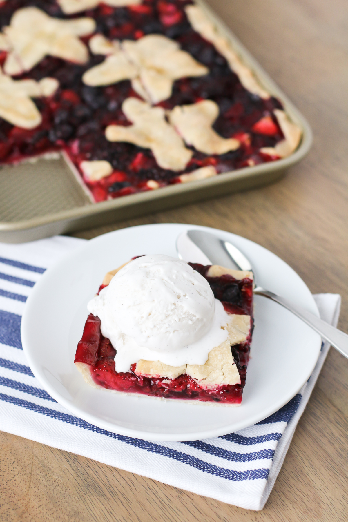 Gluten Free Vegan Triple Berry Slab Pie. Flaky pie crust, filled with fresh strawberries, blueberries and blackberries. Baked in a sheet pan until bubbly and golden brown!