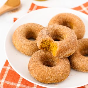 Gluten Free Vegan Cinnamon Sugar Pumpkin Donuts. Fluffy baked pumpkin donuts, dipped in cinnamon sugar. These are what donut dreams are made of!