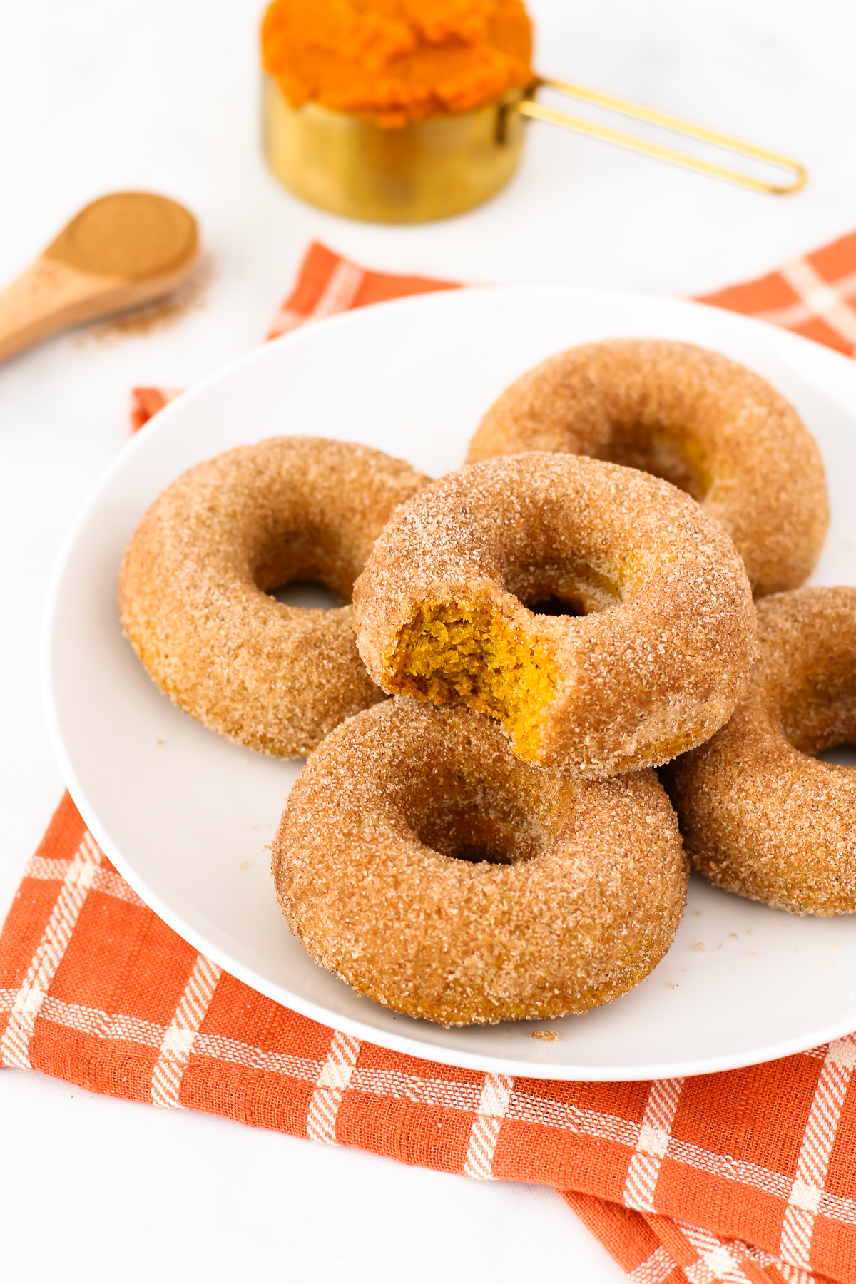 Gluten Free Vegan Cinnamon Sugar Pumpkin Donuts. Fluffy baked pumpkin donuts, coated in cinnamon sugar. These are what donut dreams are made of!