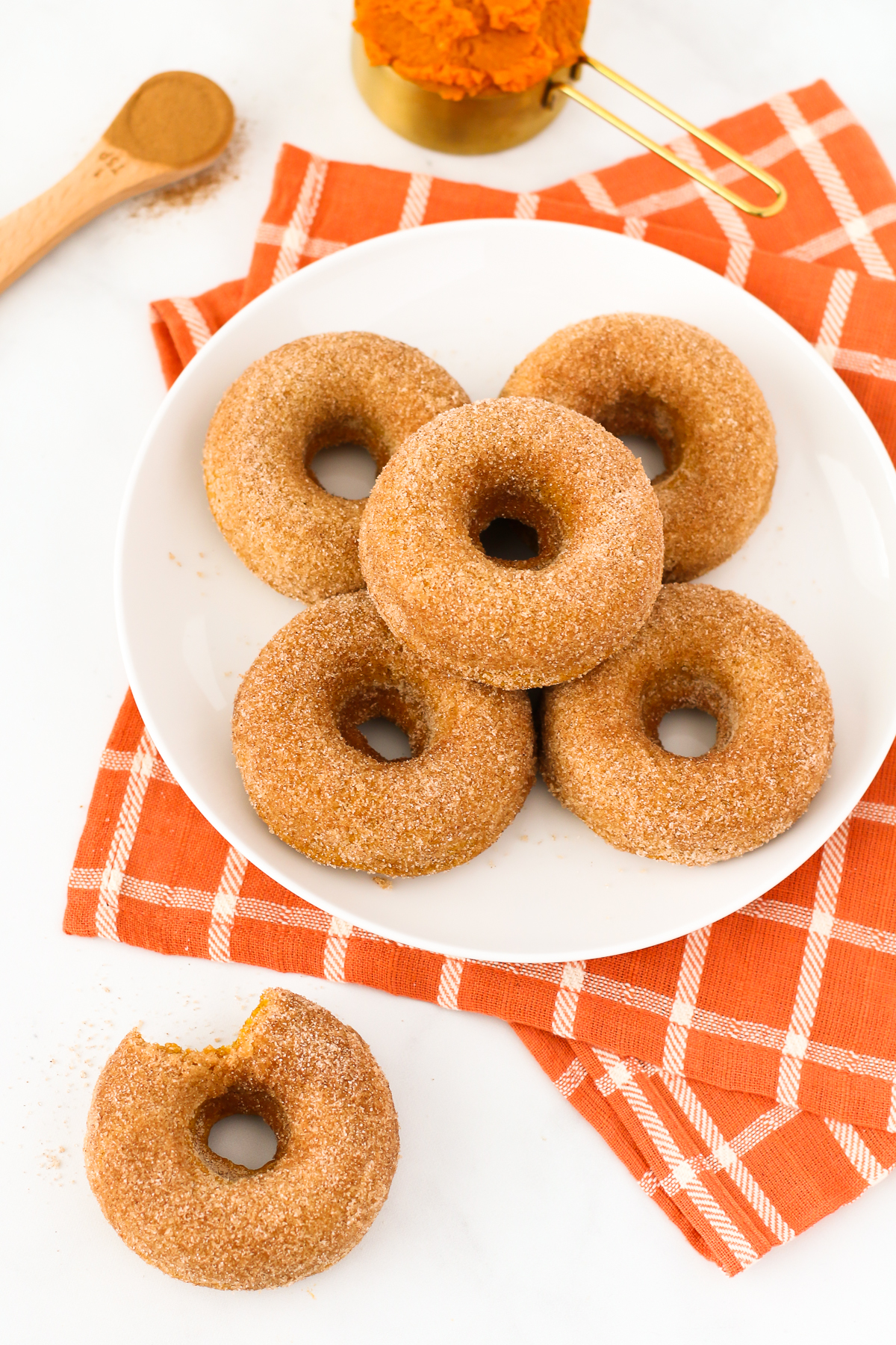 Gluten Free Vegan Cinnamon Sugar Pumpkin Donuts. Fluffy baked pumpkin donuts, coat in cinnamon sugar. The most perfect fall breakfast treat!