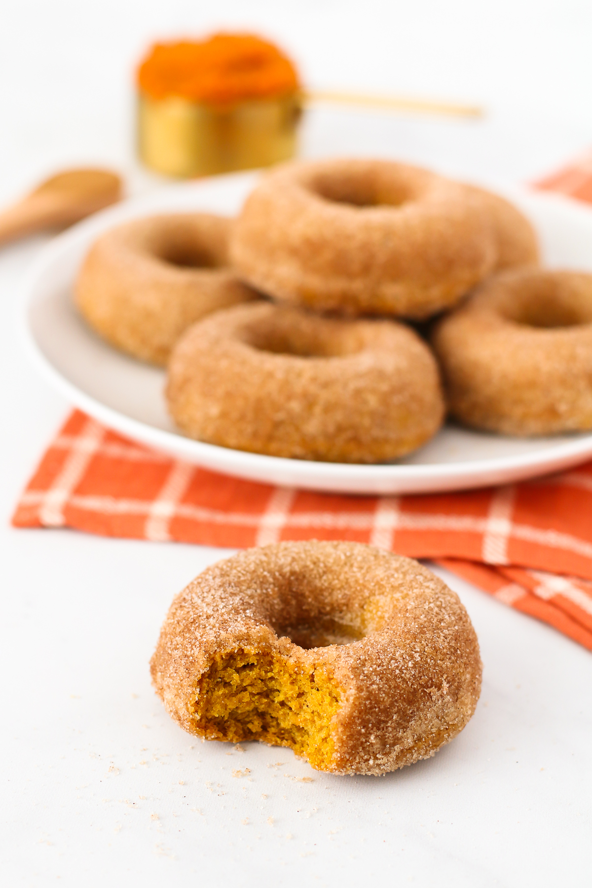 Gluten Free Vegan Cinnamon Sugar Pumpkin Donuts. Fluffy baked pumpkin donuts, coated in cinnamon sugar. These are what donut dreams are made of!