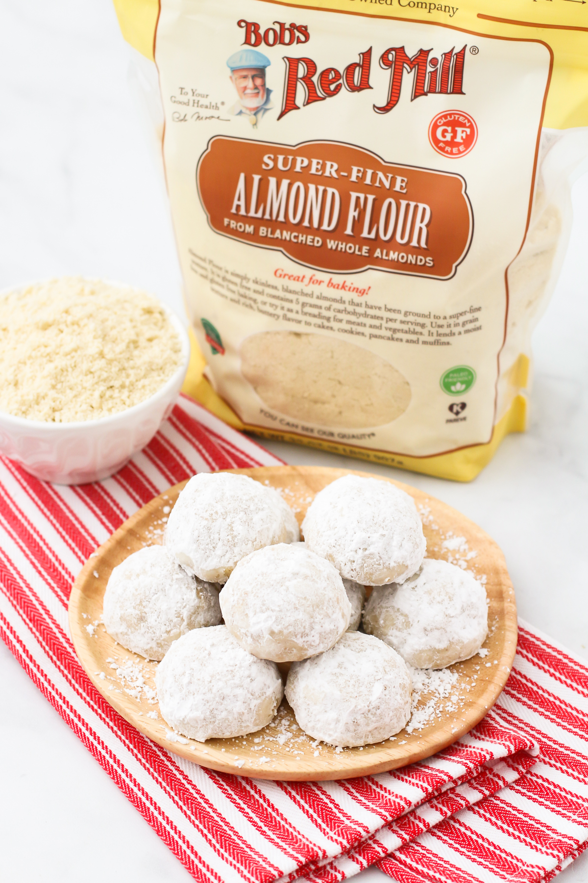 Gluten Free Vegan Snowball Cookies. These buttery, simple cookies are made with Bob’s Red Mill almond flour and toasted walnuts. Festive and flavorful!