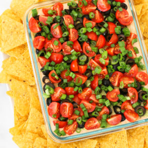 Vegan 7 Layer Bean Dip. Layers of beans, guacamole, creamy taco sauce, salsa and all of the vibrant Mexican flavors. No one will even miss the dairy!