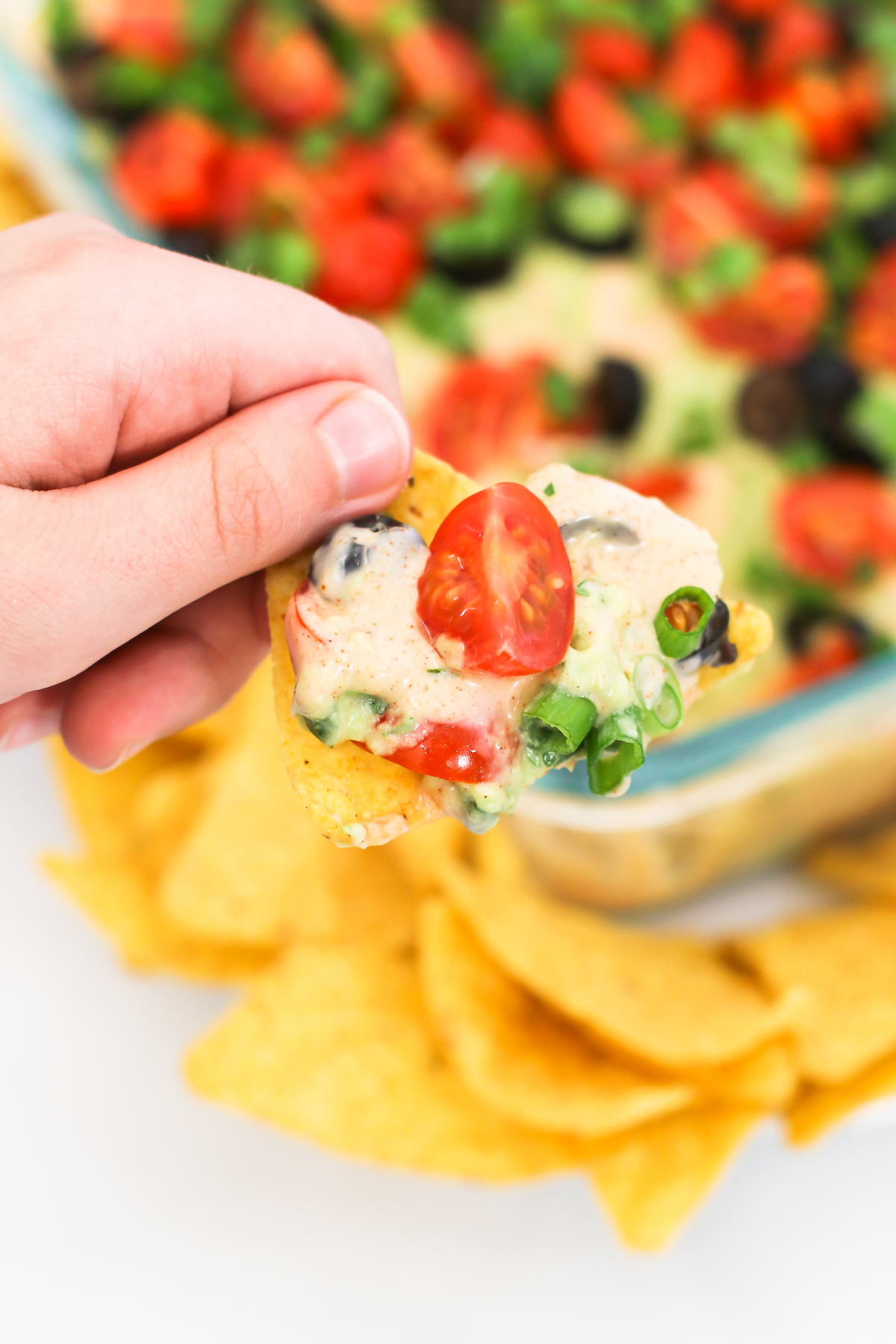 Vegan 7 Layer Bean Dip. Layers of beans, guacamole, creamy taco sauce, salsa and all of the vibrant Mexican flavors. No one will even miss the dairy! 