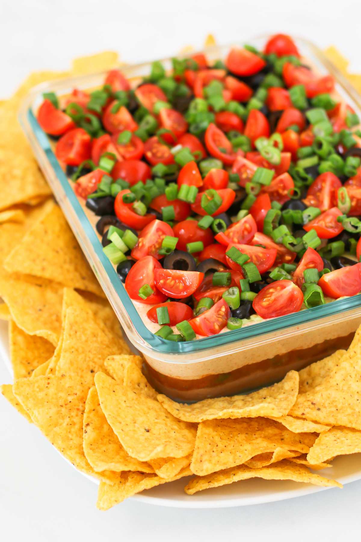 Vegan 7 Layer Bean Dip. Layers of beans, guacamole, creamy taco sauce, salsa and all of the vibrant Mexican flavors.