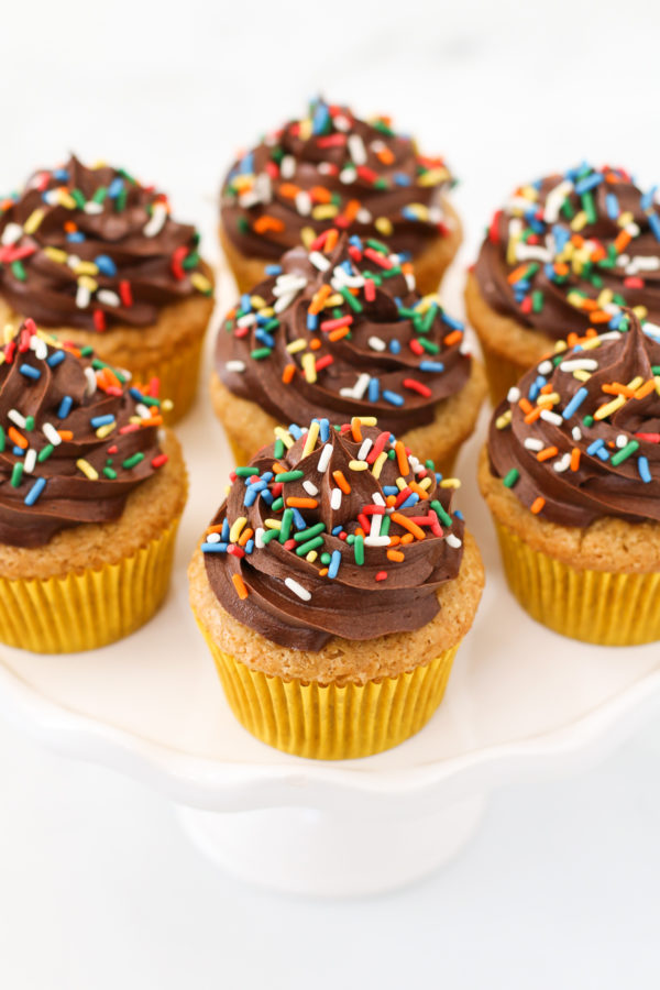 Gluten Free Vegan Vanilla Cupcakes with Chocolate Frosting. The classic flavors of a perfect vanilla cupcake, topped with a rich and creamy chocolate frosting.