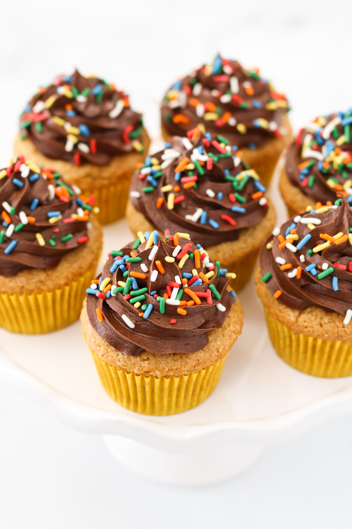 Gluten Free Vegan Vanilla Cupcakes with Chocolate Frosting. The classic flavors of a perfect vanilla cupcake, topped with a rich and creamy chocolate frosting. 