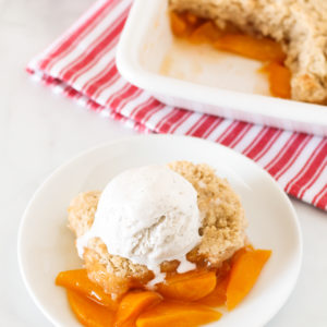 Gluten Free Vegan Peach Cobbler. Perfectly golden biscuit-like topping over sweet, juicy fresh peaches. A summertime must!