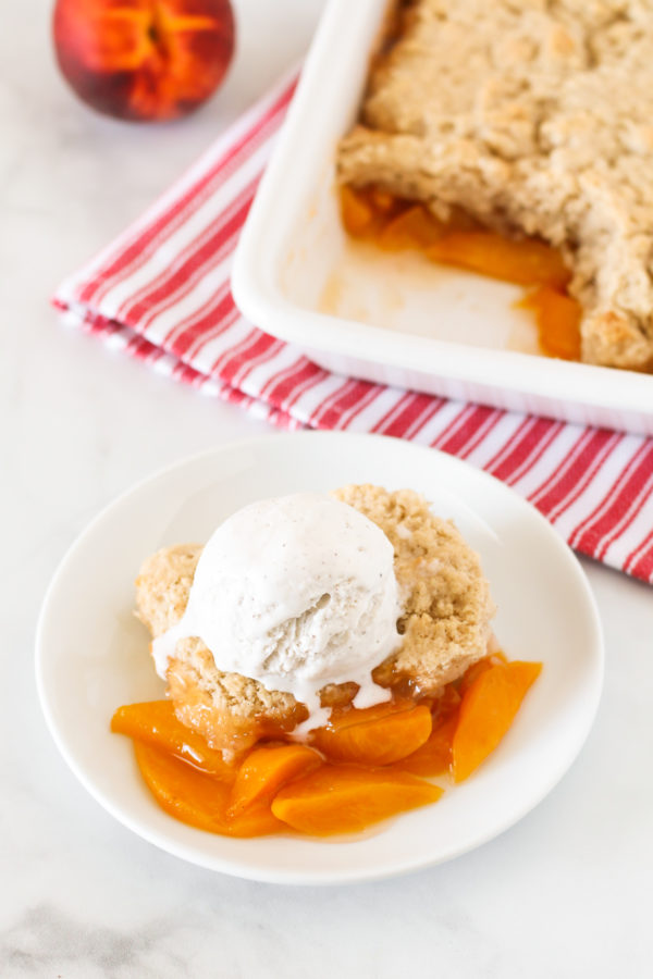 Gluten Free Vegan Peach Cobbler. Perfectly golden biscuit-like topping over sweet, juicy fresh peaches. A summertime must!