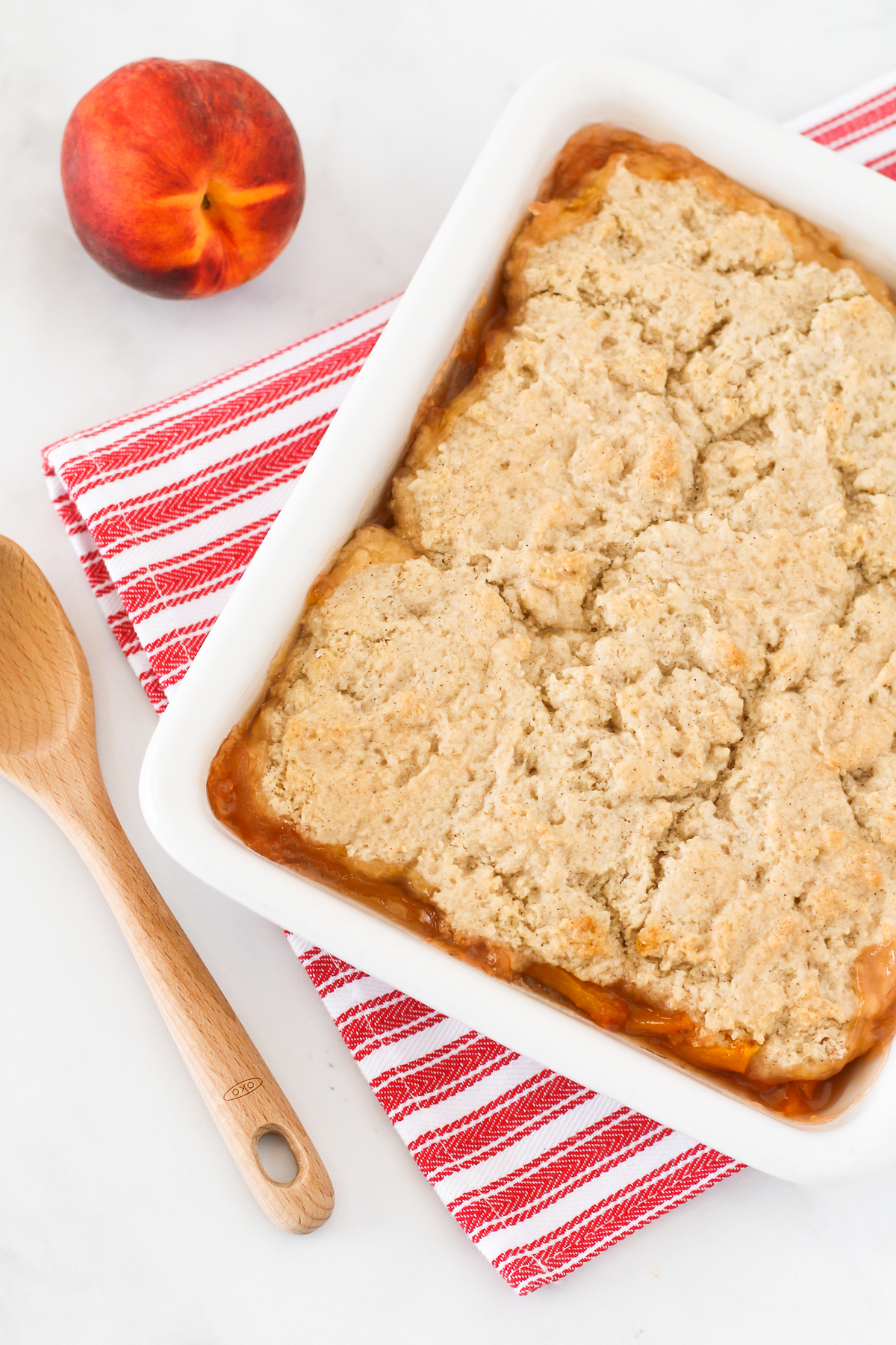 Gluten Free Vegan Peach Cobbler. Perfectly golden biscuit-like topping over sweet, juicy fresh peaches. The BEST summertime dessert!