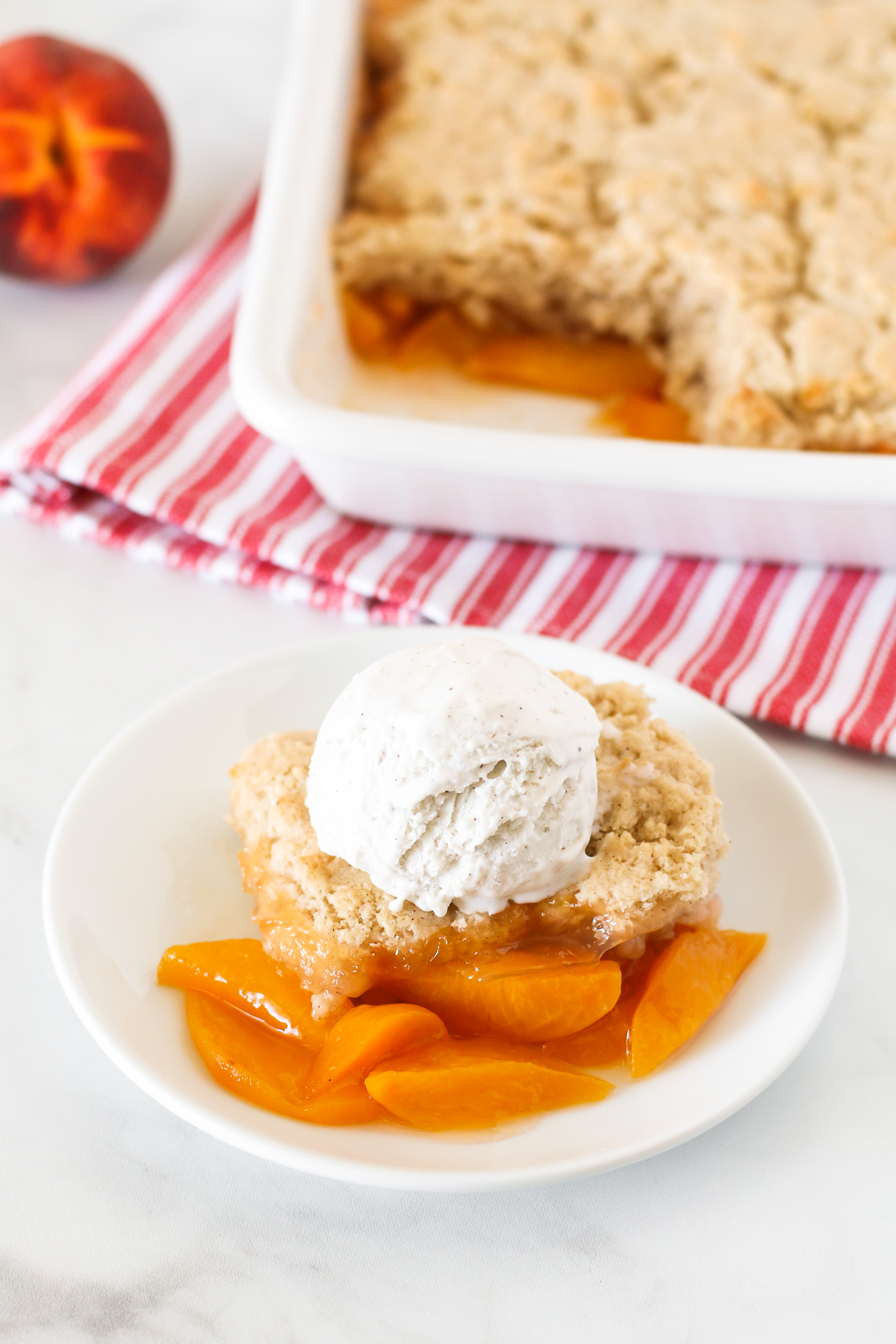 Gluten Free Vegan Peach Cobbler. Perfectly golden biscuit-like topping over sweet, juicy fresh peaches. The BEST summertime dessert!