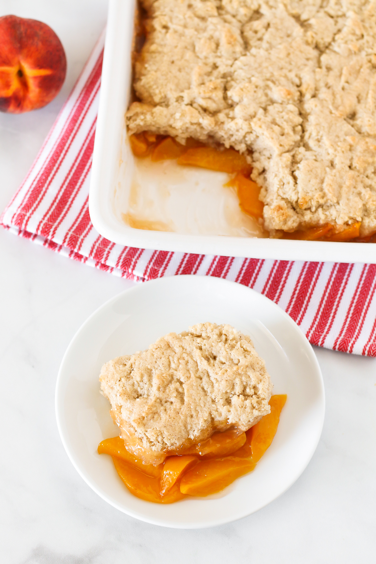 Gluten Free Vegan Peach Cobbler. Perfectly golden biscuit-like topping over sweet, juicy fresh peaches. A summertime must! 