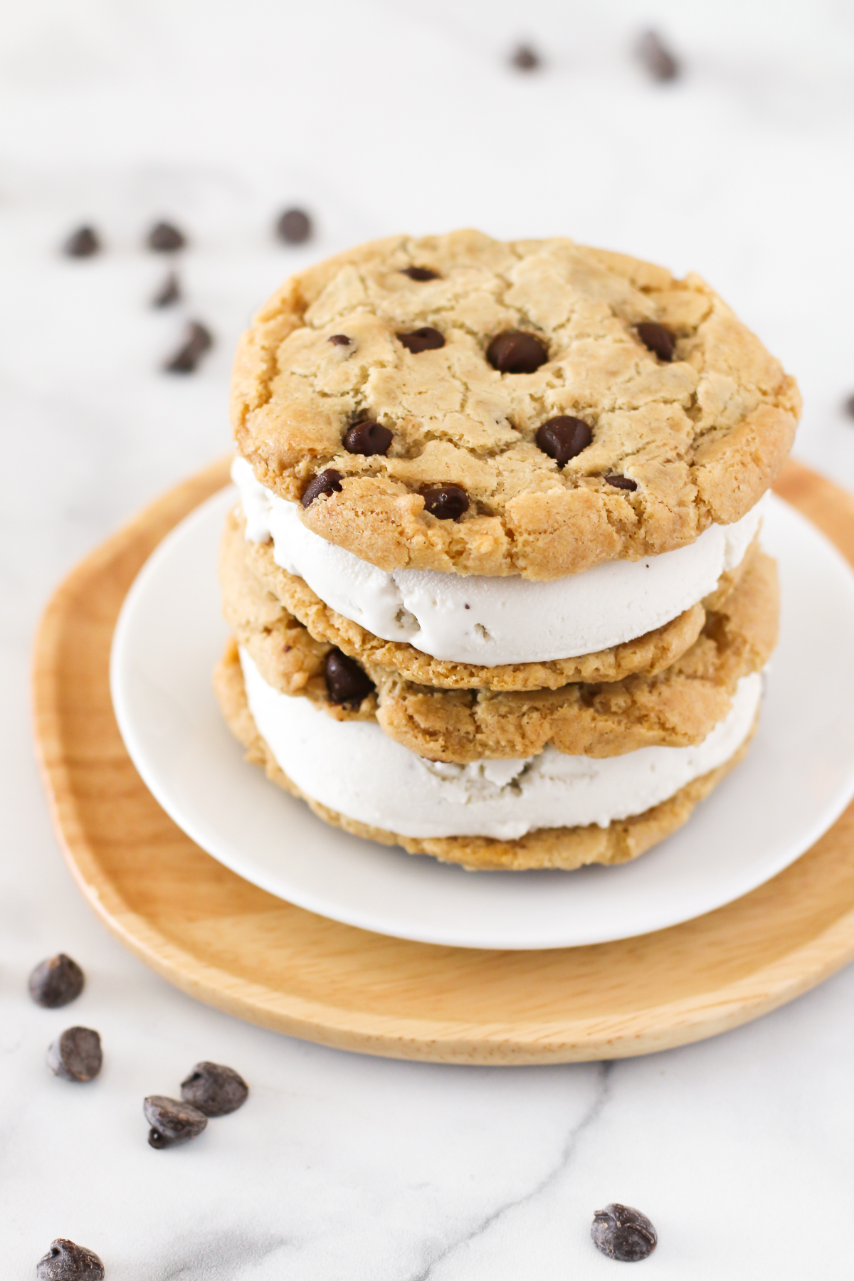 Gluten Free Vegan Chocolate Chip Cookie Ice Cream Sandwiches. Creamy vanilla ice cream, sandwiched between two chocolate chip cookies. The perfect summer treat!